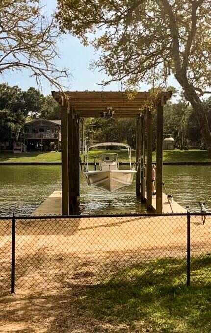 Classic sling boat lift in a boathouse on a lake providing secure and gentle boat support for waterfront storage