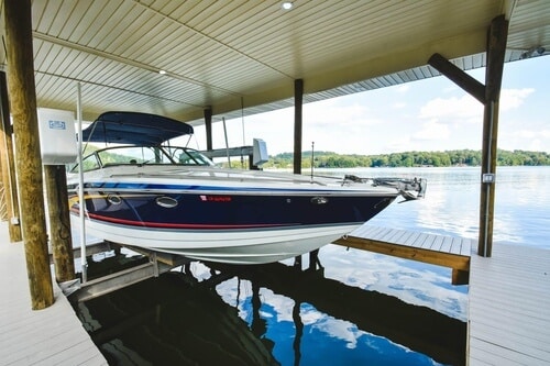 Classic cradle boat lift with boat secured on bunks for safe and stable waterfront storage