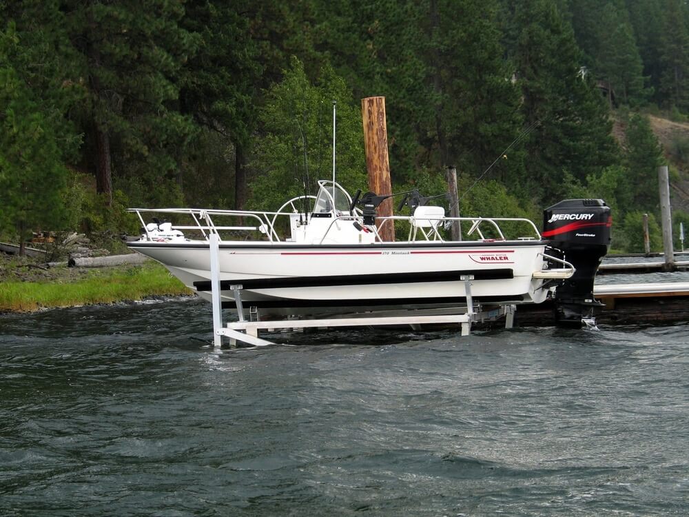 Boston Whaler supported on Hewitt cantilever boat lift with V-bunks.